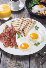 Breakfast with eggs bacon and toasts