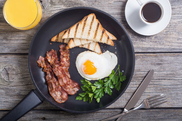 Breakfast with eggs bacon and toasts