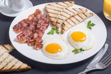 Breakfast with eggs bacon and toasts