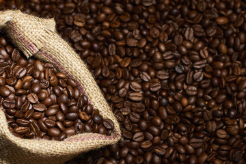 Studio Shot of Burlap Bag with Coffee over coffee beans