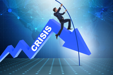 Businessman pole vaulting over crisis in business concept