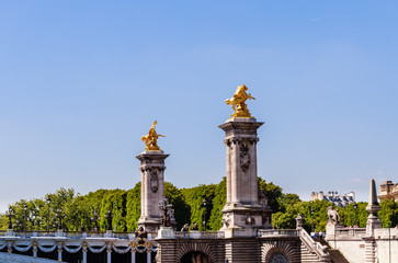 Fototapeta na wymiar Fragment of the Alexander III Bridge across the Seine in Paris, France. View from the water
