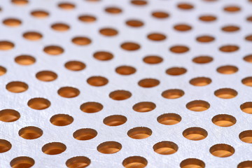Abstract background of metal surface with holes