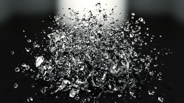 The destruction of the glass sphere in slow motion on a black background