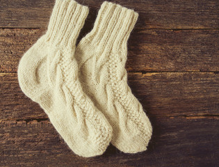 beautiful warm woolen socks on wooden surface