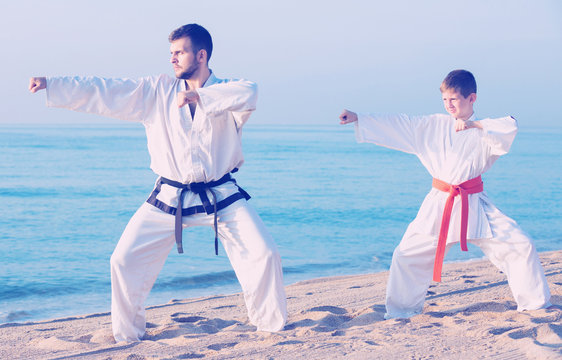 Man and boy exercising karate