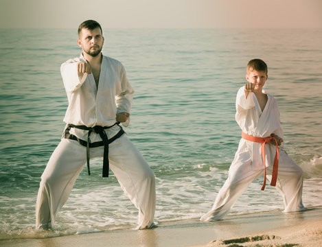 Father and son are practicing karate