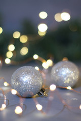 silver balls for Christmas tree and bright lights of garland
