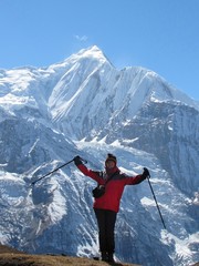 young woman tourist on the background of a snowy peak in the Himalayas