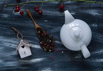 Valentine's day concept, white teapot and small bird house on blue and white background, natural light, top view