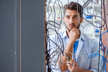 Computer repairman working on repairing network in IT workshop