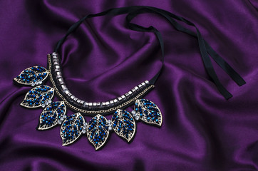 collar necklace with beads isolated on silk