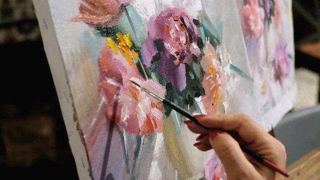 Artist paints oil painting on canvas