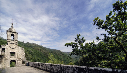 Fototapeta premium Entrance and stone belfry of the ancient Monastery of Caaveiro, dating from the 10th century and which was home to hermits of the area, in Galicia, Spain.