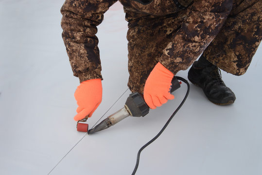 Waterproofing and insulation at construction site, roof sealing process of synthetic membrane with Hot Air Hand Tool. New protection technology. Closeup.