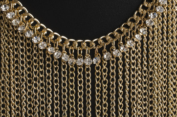 gold necklace with chains and diamonds isolated on black