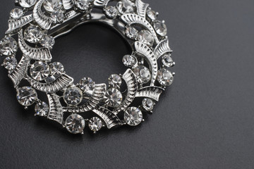 round brooch with diamonds isolated on black
