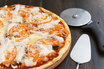 fresh and delicious Italian pizza on a wooden table and a pizza knife