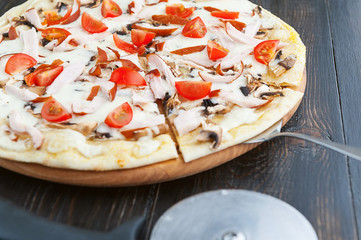 fresh and delicious Italian pizza on a wooden table and a pizza knife
