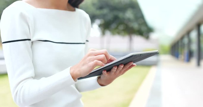 Woman touching on tablet computer at night