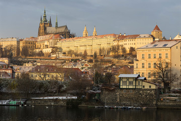 Early Morning Christmas snowy Prague Lesser Town with gothic Castle above River Vltava, Czech republic