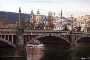 Early Morning Christmas snowy Prague Lesser Town with gothic Castle above River Vltava, Czech republic