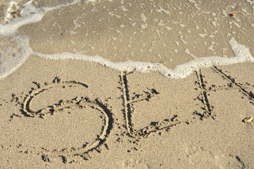 sea written in a sandy tropical beach
