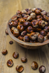 Chestnuts in an old copper bowl on an old wooden table