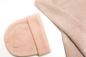 Kit of knitted pink hat and scarf isolated on white background