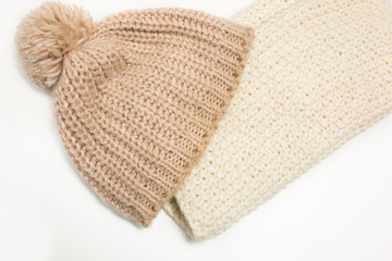 Fototapeta na wymiar Large-knitted hat and white scarf snud on white background