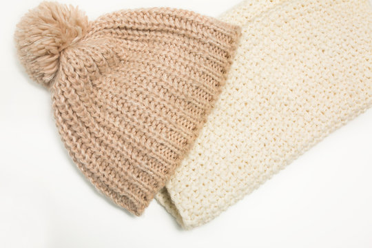 Large-knitted hat and white scarf snud on white background