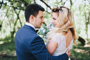 Faces of newlyweds in profile. Happy smiling bride and groom.