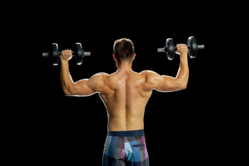 Fototapeta na wymiar Athlete making exercises with dumbbells. Building perfect biceps by lifting weight. Strong and muscular body.