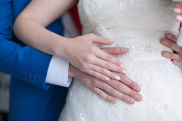 Hands of bride and groom before wedding ceremony