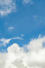 Obraz premium The vertical view of light blue sky with white clouds for background or texture. Copy space