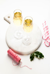 Two glasses with champagne on the table with decorations for Christmas. New Year's style