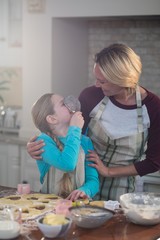 Mother and daughter having fun while preparing cookies in