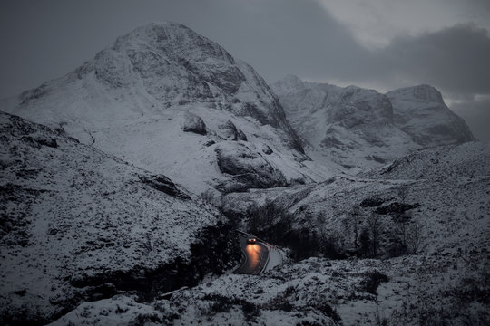 Car moving on the mountain road against snowcapped mountain