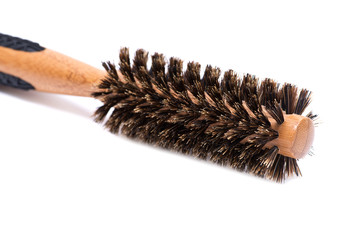 Round natural bamboo hairbrush with wild boar bristles isolated on white background