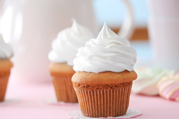 Delicious cupcake on table