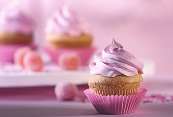 Delicious cupcake on table