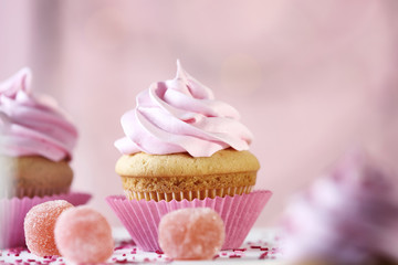 Delicious cupcake on table