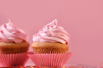 Delicious cupcakes on color background, closeup