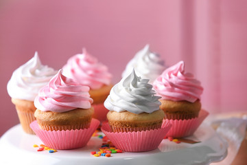 Dessert stand with delicious cupcakes on blurred background
