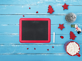 chalkboard in a red frame on a blue wooden background