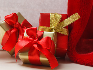 Small red and golden boxes with gifts tied bows