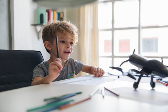 Boy Drawing An Airplane