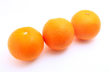 Three mandarin oranges shot over white background