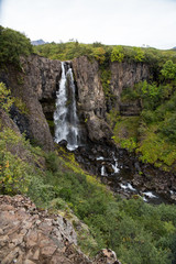 Obraz premium A waterfall falling from a cliff in Iceland. 
