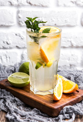 citrus lemonade on a white brick wall background